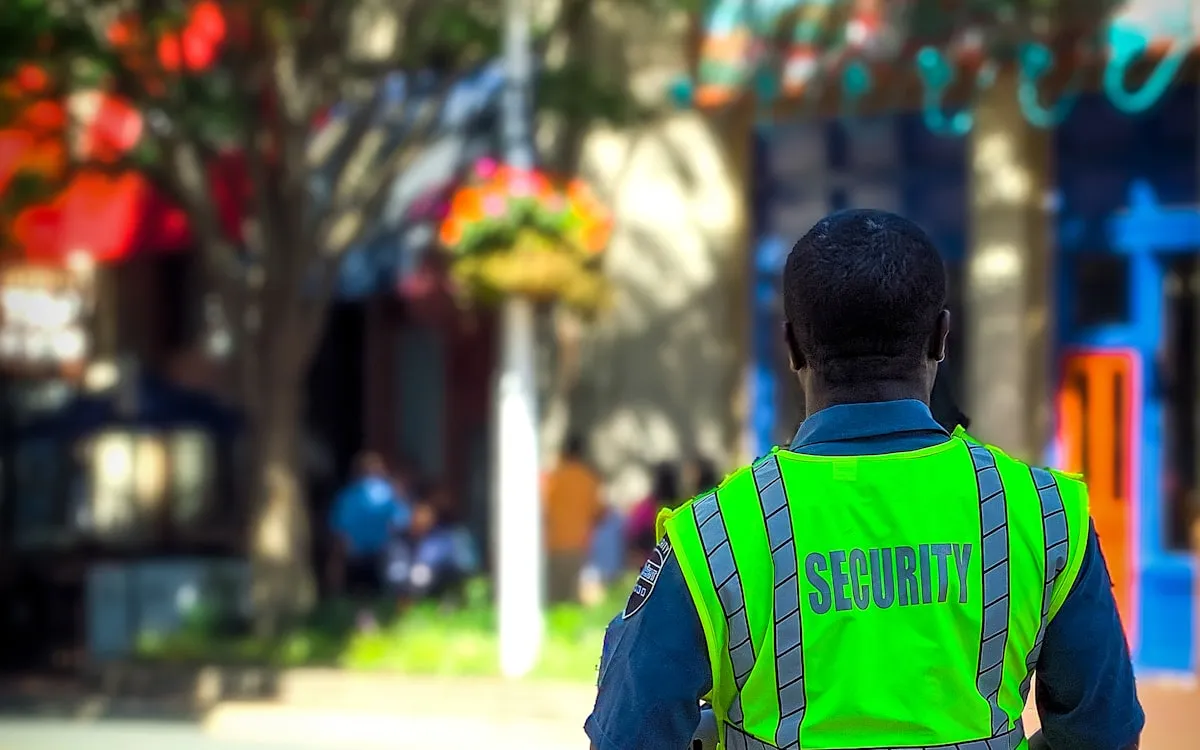 Security officer at an event access point in the evening